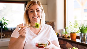 Woman eating a salad.